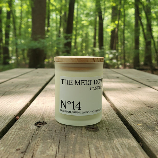 Jar labeled 'The Melt Down Candle Co.' on a textured surface with a blurred background