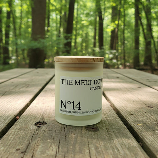Jar labeled 'The Melt Down Candle Co.' on a textured surface with a blurred background
