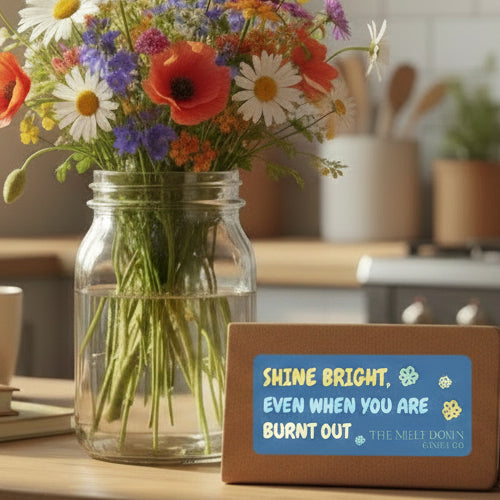 Motivational card with text 'Shine bright, even when you are burnt out' and branding for The Melt Down Candle Co on a blue background.